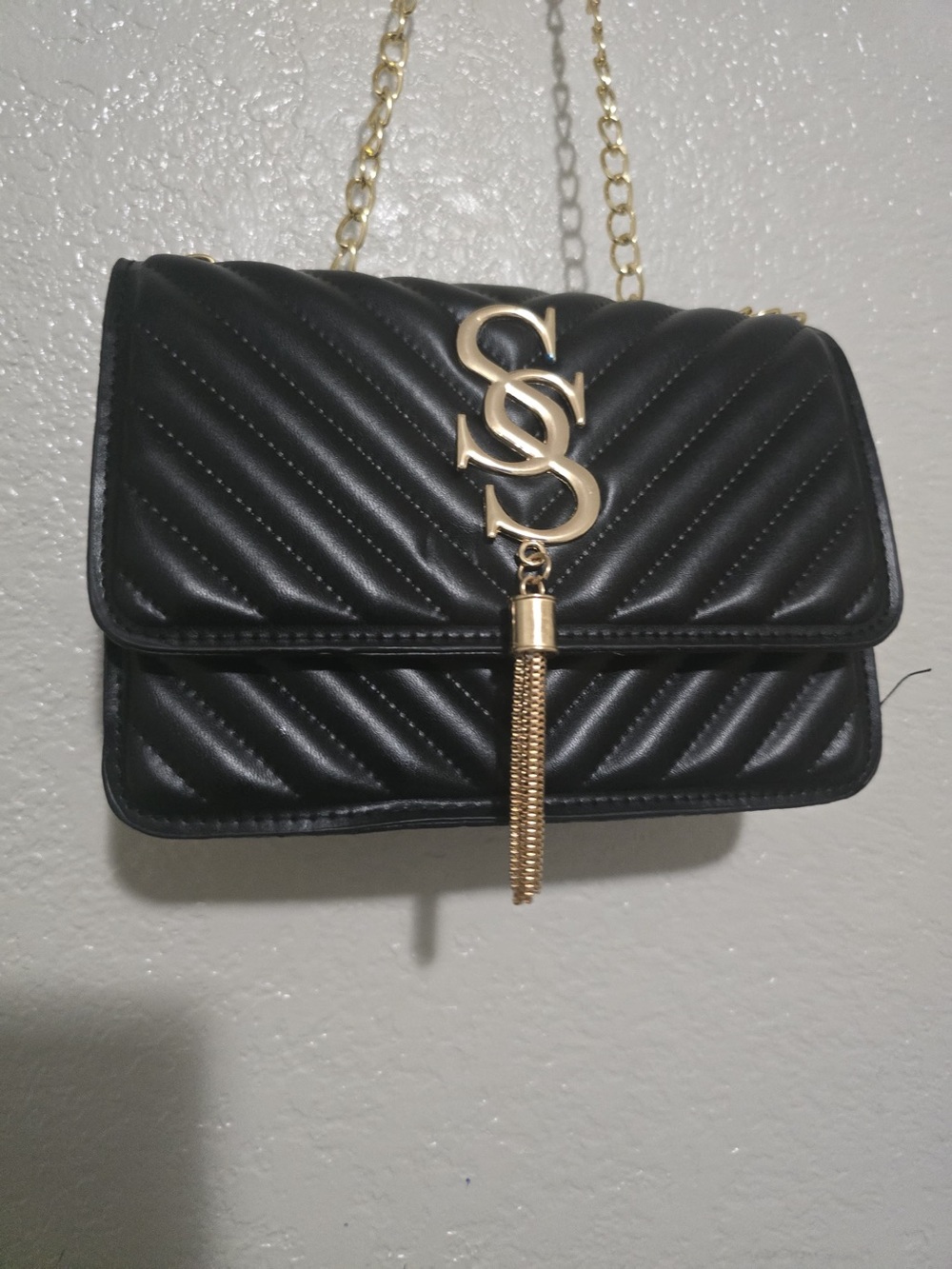 Black Quilted Shoulder Bag with Gold Tassel Accent